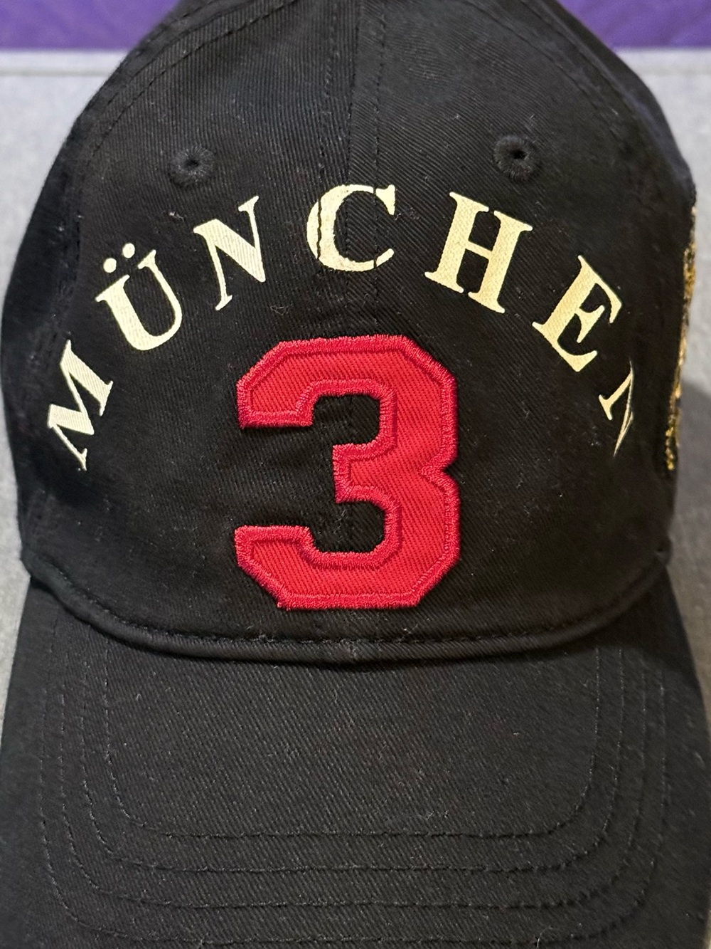 Robin Ruth Black Cap with Red Number 3 and Cream MÜNCHEN Text